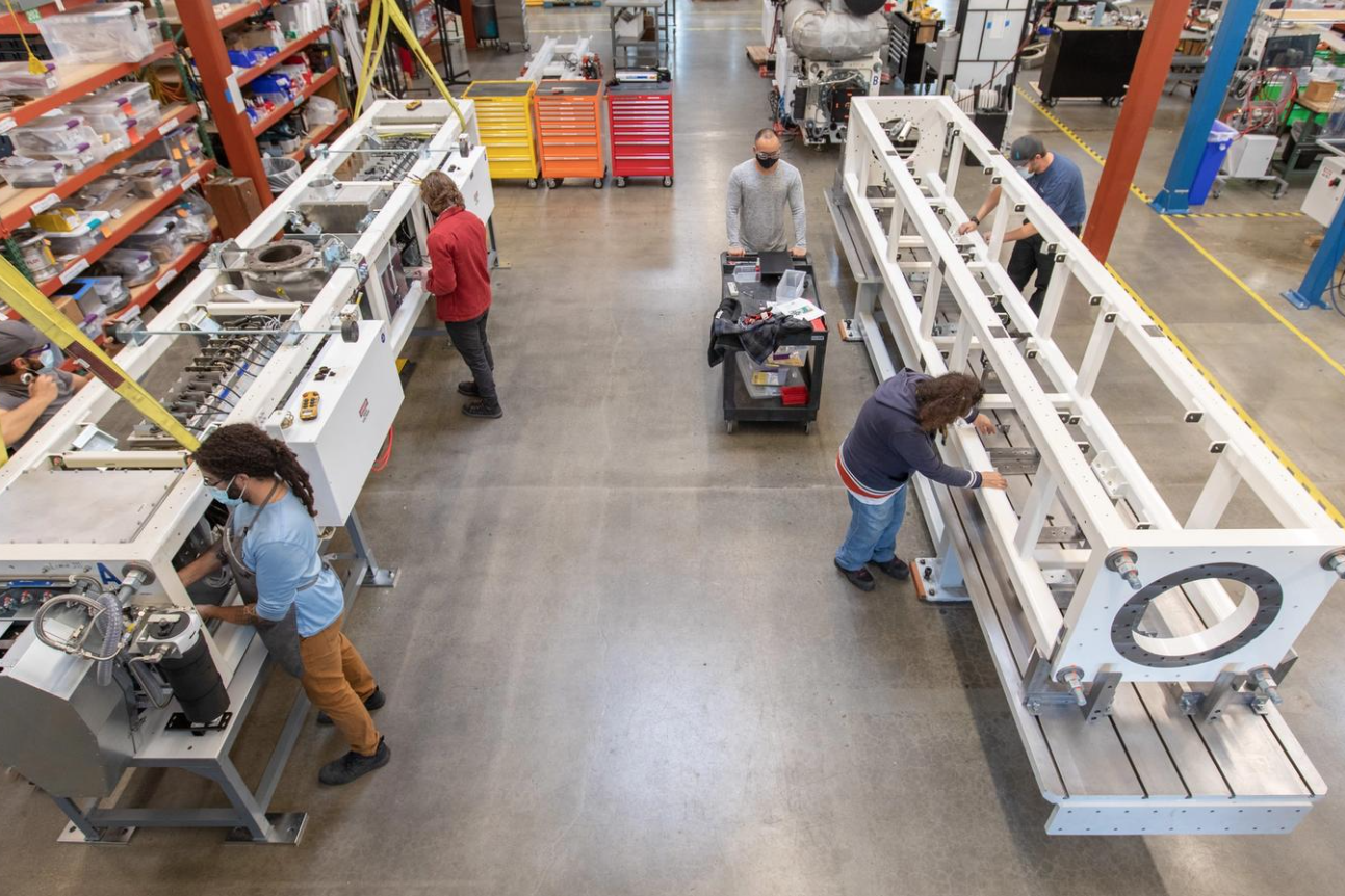 Lineage Logistics' staff is seen operating the 20-foot long generators, built by Mainspring Energy Inc. 

Image Source: DC Velocity 